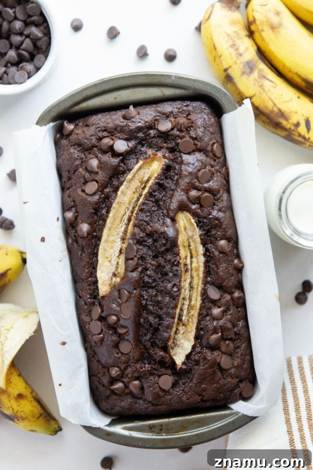 Decadent Double Chocolate Banana Bread 3 Close-up of a slice of double chocolate banana bread revealing its moist texture and melted chocolate chips.