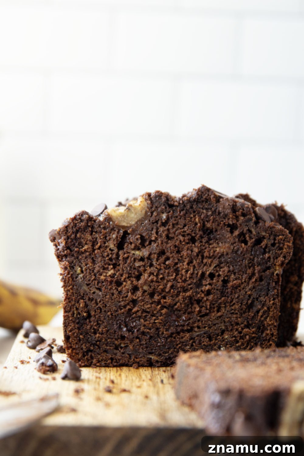 Decadent Double Chocolate Banana Bread 6 A perfectly sliced piece of double chocolate banana bread on a plate, ready to be enjoyed.