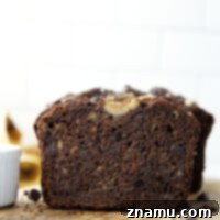 Deliciously moist double chocolate banana bread, packed with rich cocoa and gooey chocolate chips.