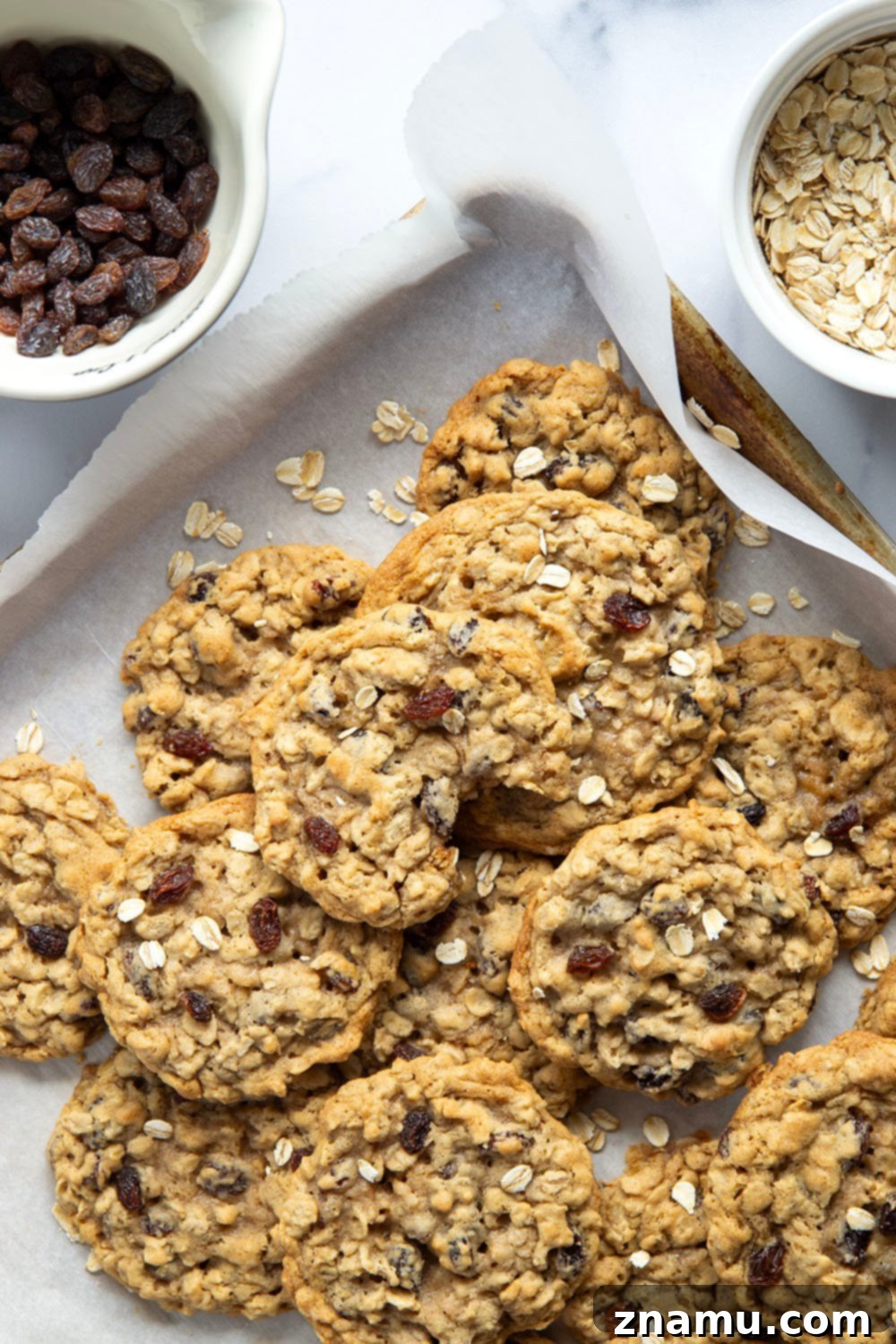 Soft & Chewy Oatmeal Raisin Bliss 6 A stack of perfectly baked soft and chewy oatmeal raisin cookies on a rustic plate.