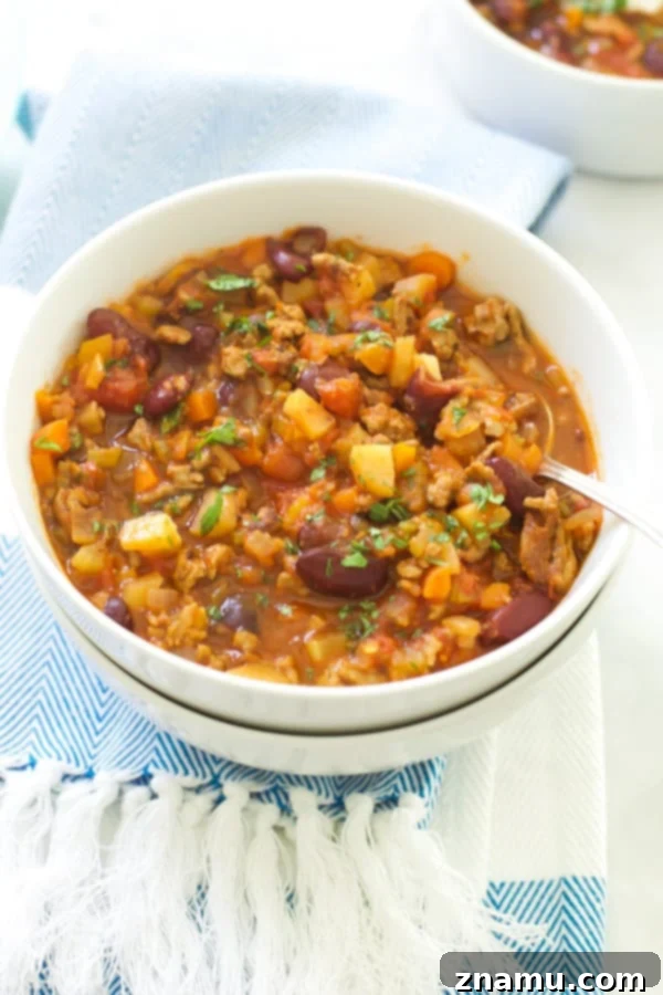 Extra-Lean Turkey Chili with Carrots and Turnips 6 A bowl of Extra-lean Turkey Chili with Carrots and Turnips topped with sour cream and cilantro