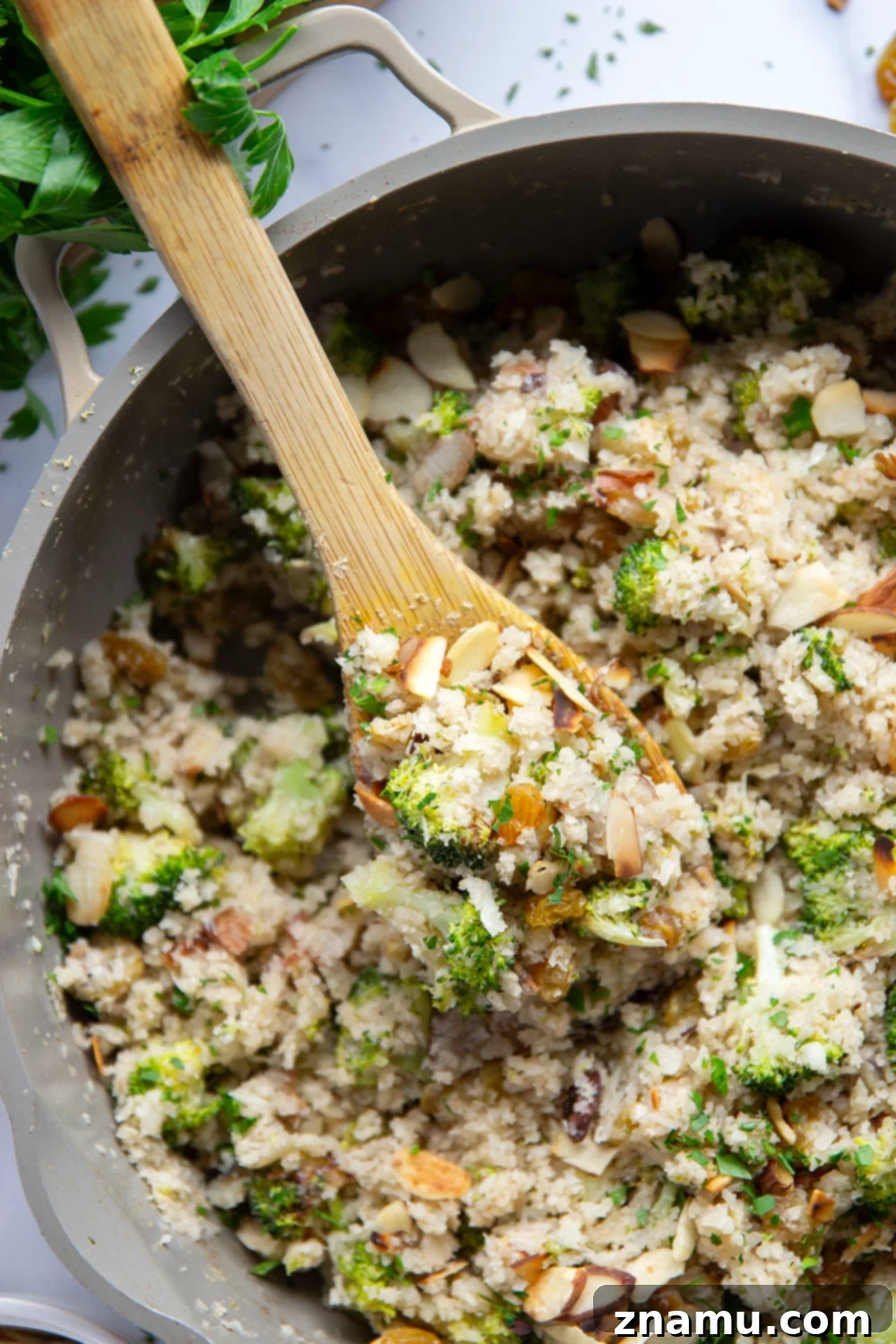 Flavorful Cauliflower Rice Pilaf 6 Cauliflower Rice Pilaf served in an elegant white bowl, garnished with fresh parsley and ready to be enjoyed as a healthy side dish.