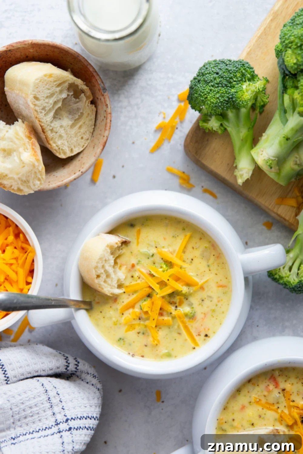 Quick and Creamy Broccoli Cheddar Soup 2 A steaming bowl of homemade broccoli cheddar soup, garnished with extra shredded cheddar and fresh broccoli florets, ready to be enjoyed with a side of crusty bread.
