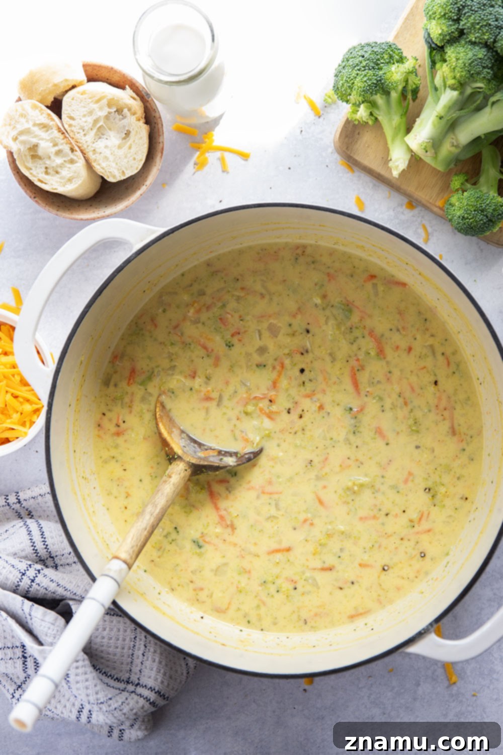Quick and Creamy Broccoli Cheddar Soup 3 Close-up shot of the thick, creamy texture of broccoli cheddar soup, showcasing tender broccoli florets and shredded carrots.