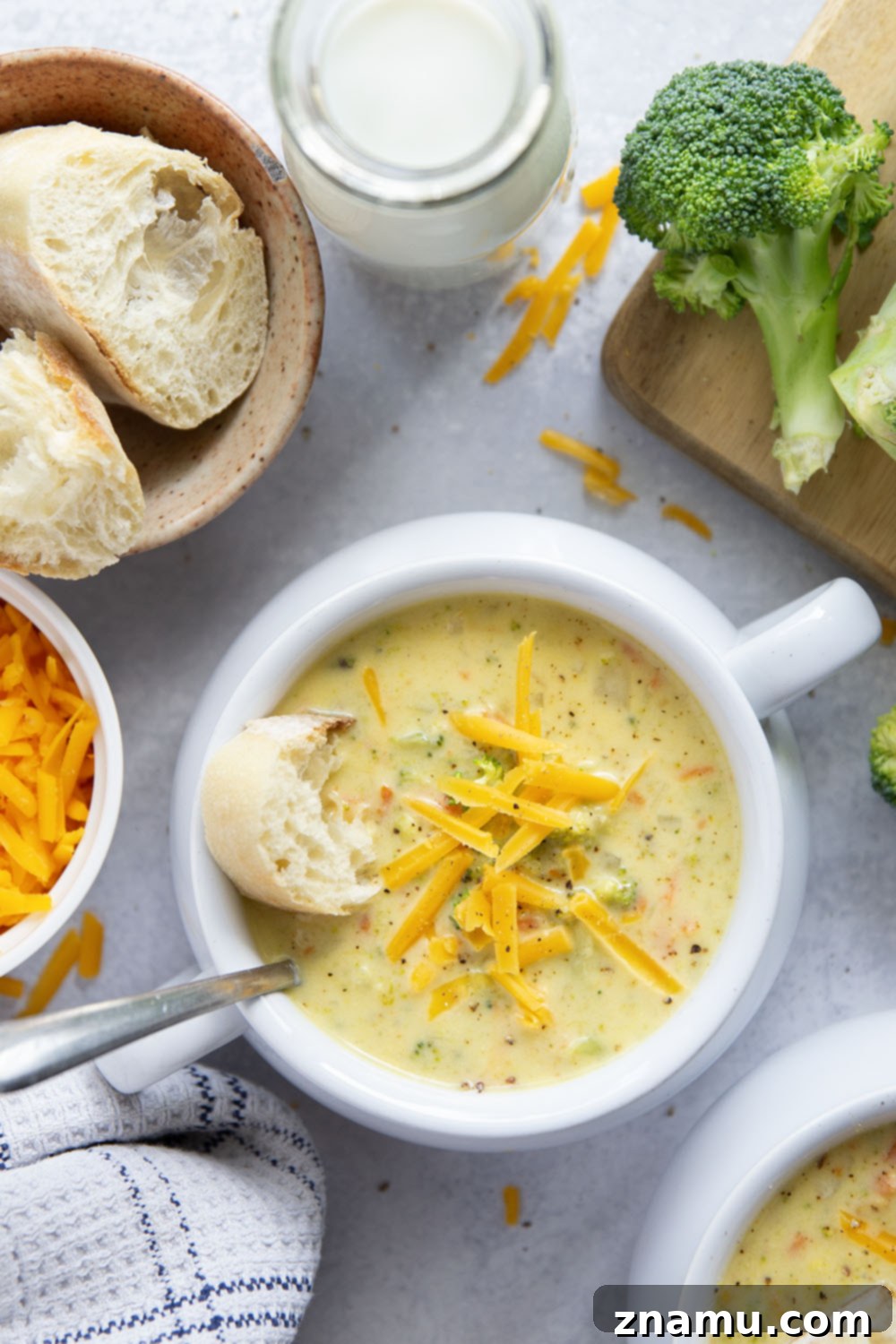 Quick and Creamy Broccoli Cheddar Soup 4 A vibrant bowl of broccoli cheddar soup with steam rising, indicating its warmth and freshness. Overhead shot of the soup with a spoon.