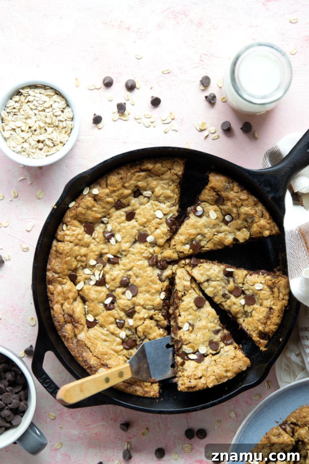 Warm Skillet Chocolate Oat Treat 2 A perfectly baked, soft and chewy chocolate chip oatmeal skillet cookie, fresh from a cast iron pan, ready to be served. Ideal for an easy dessert recipe.