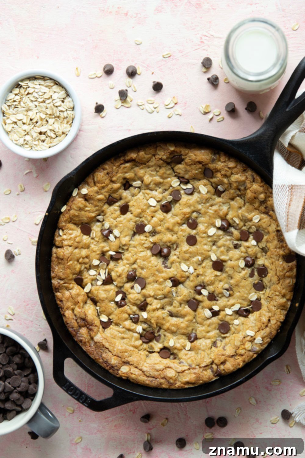 Warm Skillet Chocolate Oat Treat 3 Close-up of a warm oatmeal skillet cookie with melted chocolate chips, hinting at its soft and chewy texture. Perfect for an easy cast iron dessert.