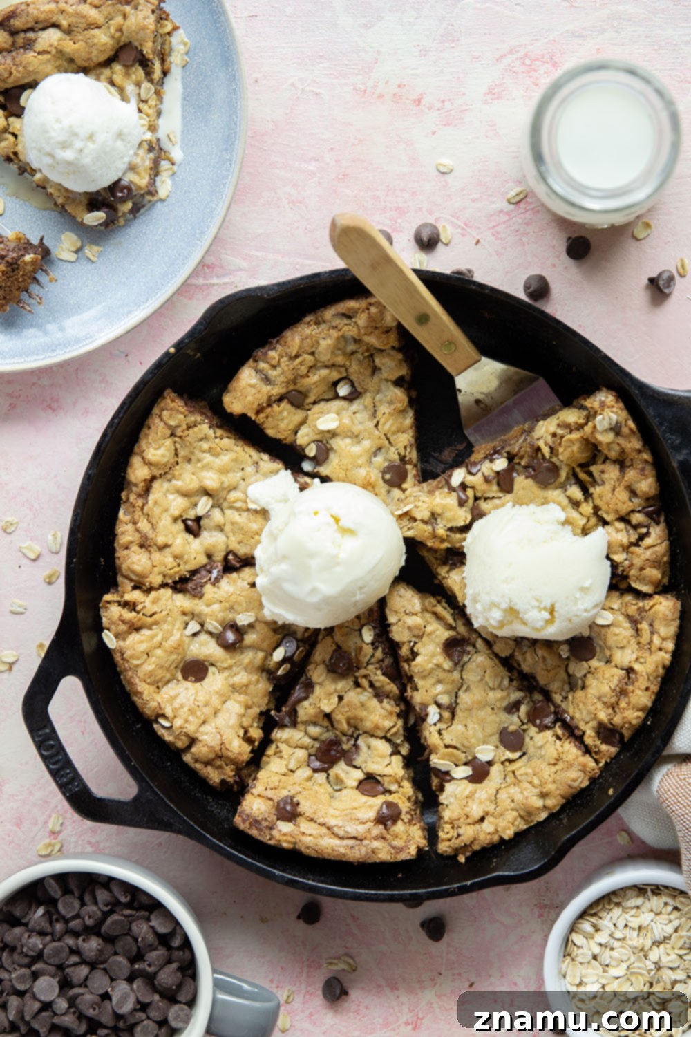 Warm Skillet Chocolate Oat Treat 6 A wedge of chocolate chip oatmeal skillet cookie topped with a scoop of vanilla ice cream and a drizzle of caramel sauce, ready to be enjoyed.