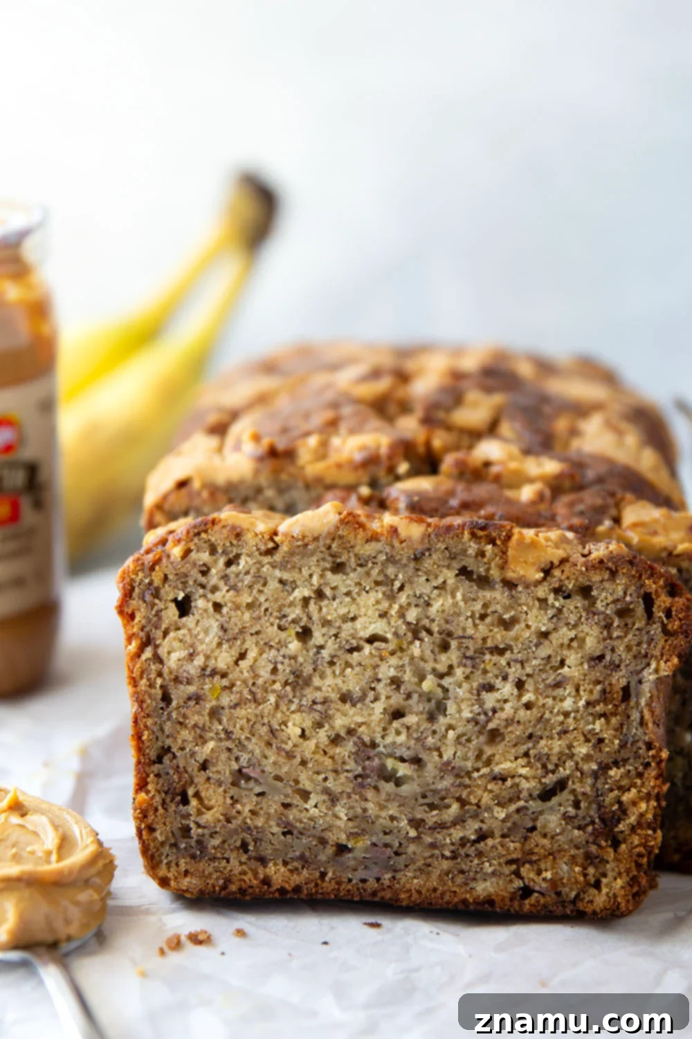 Nutty Banana Bread Bliss 5 Freshly baked peanut butter banana bread cooling on a wire rack, its beautiful swirl topping visible.