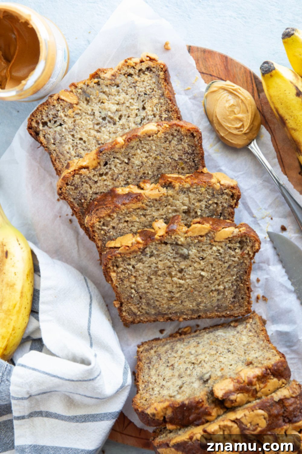 Nutty Banana Bread Bliss 6 A large slice of peanut butter banana bread on a serving plate, inviting you to take a bite.