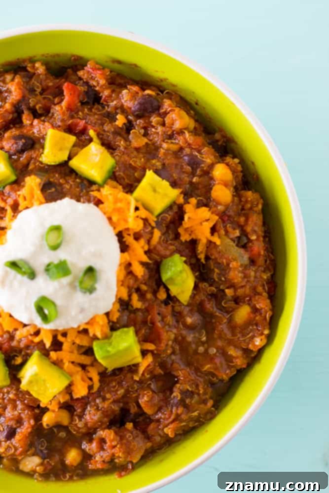 Plant-Powered Slow Cooker Quinoa and Black Bean Chili 5 Overhead shot of a large batch of Vegan Crockpot Quinoa and Black Bean Chili in a slow cooker, emitting steam and rich aromas.