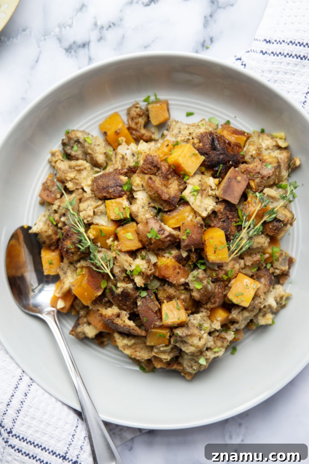Autumn's Slow-Cooked Sweet Potato Stuffing 3 Close-up of moist slow cooker sweet potato stuffing with fragrant herbs.