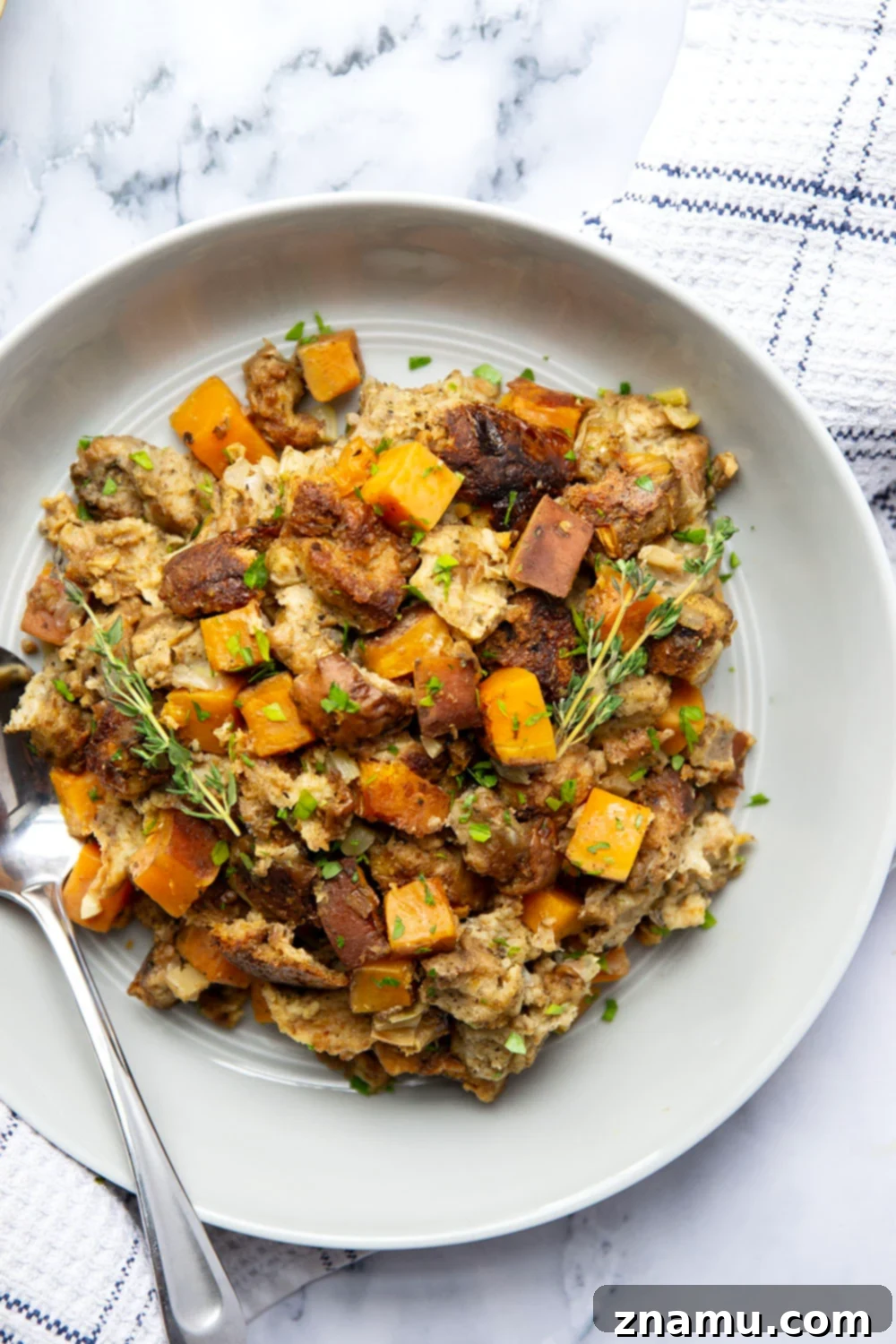 Autumn's Slow-Cooked Sweet Potato Stuffing 6 A generous serving of slow cooker sweet potato stuffing garnished with fresh parsley.