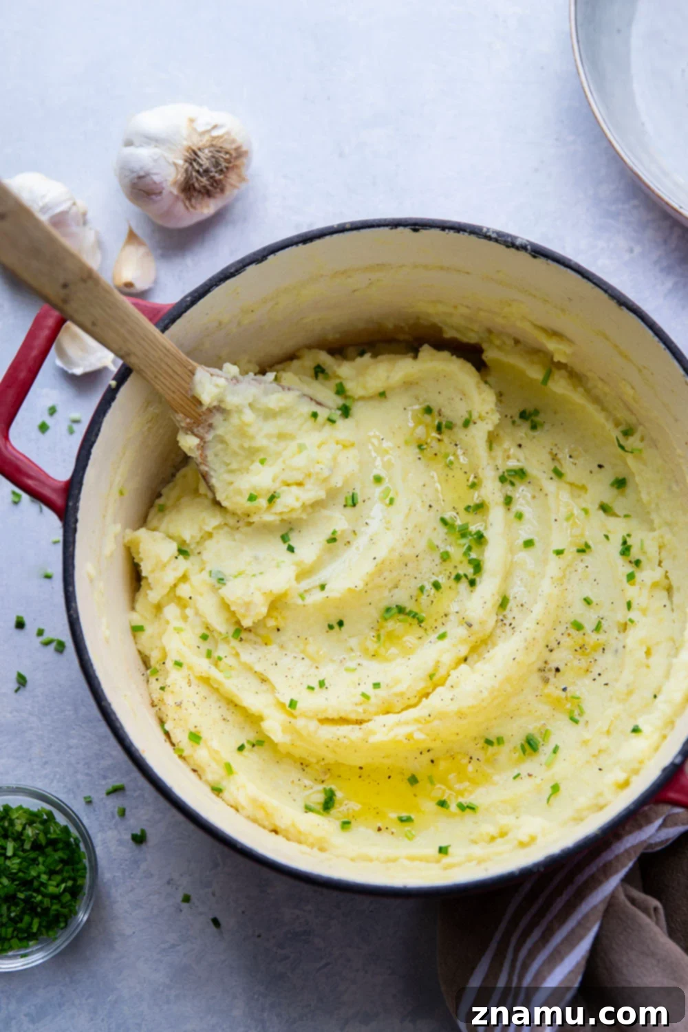 Velvety Garlic Mashed Potatoes 5 Ingredients for creamy garlic mashed potatoes laid out on a kitchen counter.