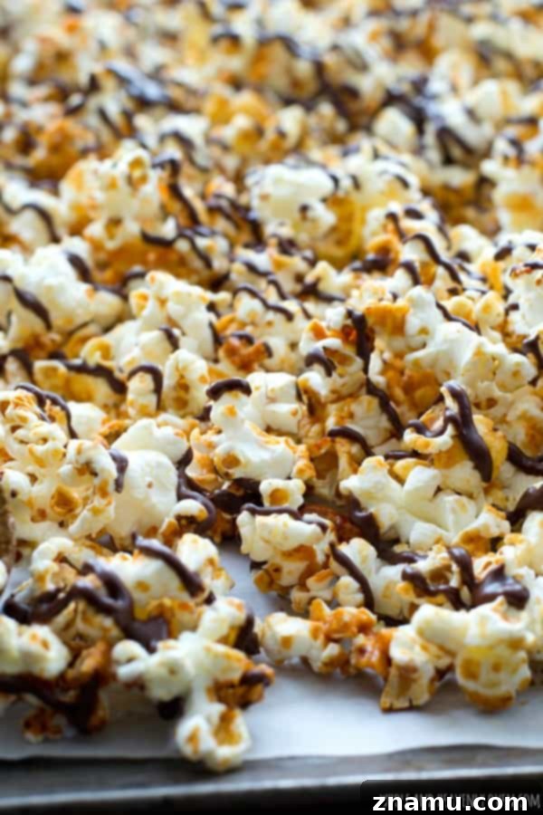 Chocolate Peanut Caramel Popcorn Crunch 4 Close-up of freshly made caramel popcorn with chocolate and peanuts