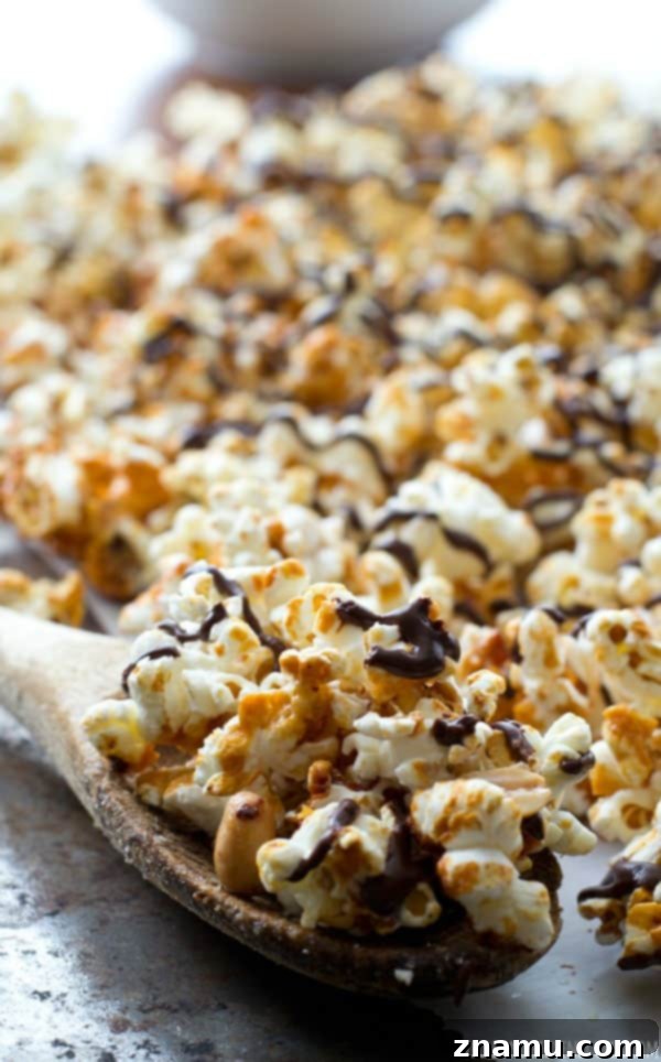 Chocolate Peanut Caramel Popcorn Crunch 5 A bowl overflowing with crunchy chocolate and peanut caramel popcorn