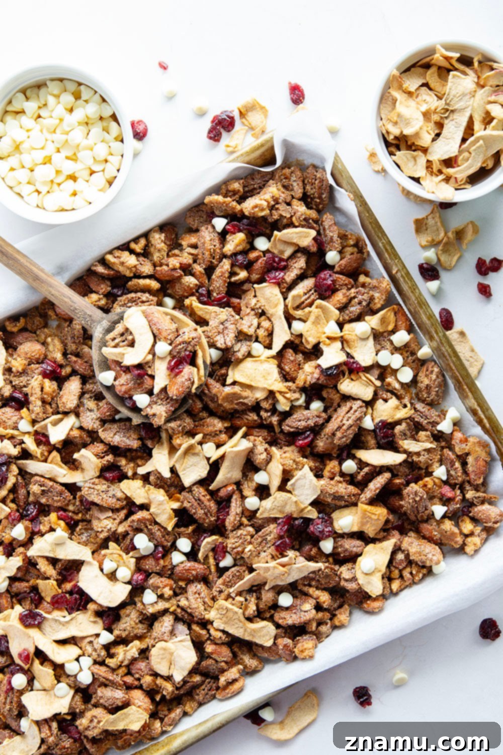 Sweet & Tangy Orchard Crunch 4 A large bowl filled with the freshly made candied nut, cranberry, and apple snack mix, ready to be enjoyed.
