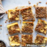 Silky cheesecake and a luxurious honey pecan pie topping are the perfect duo in these pecan pie cheesecake bars! They make a great addition to any holiday dessert table.