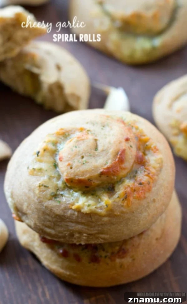 Irresistible Garlic Cheese Spirals 2 A beautiful stack of freshly baked cheesy garlic spiral rolls, perfectly golden and showcasing the delicious melted cheese and garlic within, ready to complement any meal.