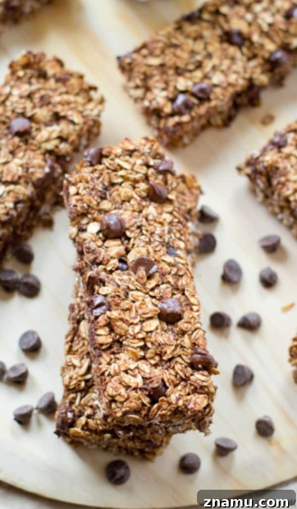 Close-up of a soft and chewy banana chocolate granola bar with visible oats and chocolate chips. @WholeHeavenly