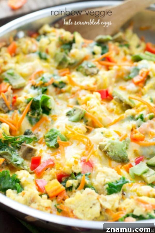 Delicious Rainbow Veggie Scrambled Eggs on a plate, featuring kale, carrots, and bell peppers