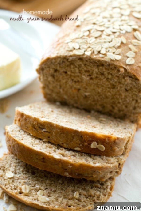 Hearty Homemade Multi-Grain Sandwich Loaf 2 Freshly baked whole grain sandwich bread loaf on a cutting board