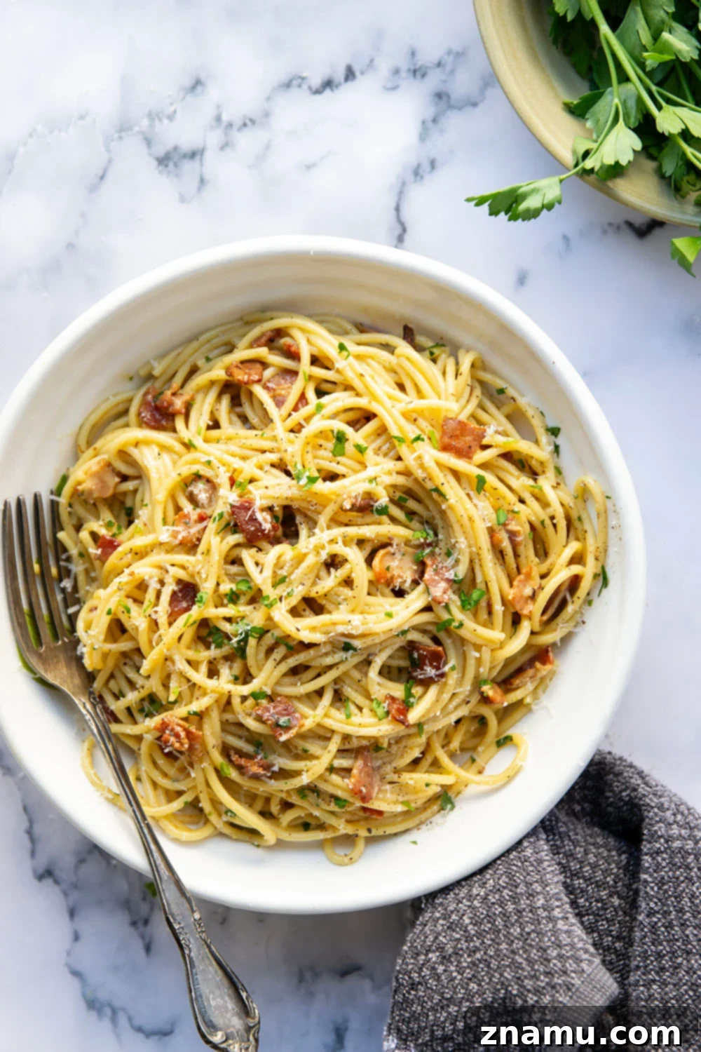 Ultimate Bacon Spaghetti Carbonara 2 This classic spaghetti carbonara features crispy bacon bits and tender spaghetti noodles in a rich and creamy Parmesan egg sauce. Ready in minutes and goes well with any meal!