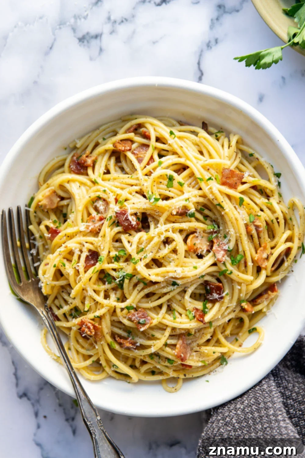 Ultimate Bacon Spaghetti Carbonara 3 This classic spaghetti carbonara features crispy bacon bits and tender spaghetti noodles in a rich and creamy Parmesan egg sauce. Ready in minutes and goes well with any meal!