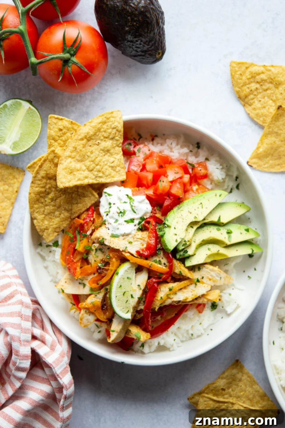 Zesty Chicken Fajita Rice Bowls 2 Everything you love about classic chicken fajitas are piled into these chicken fajita rice bowls that are made on a sheet pan for less mess and easy to meal prep!