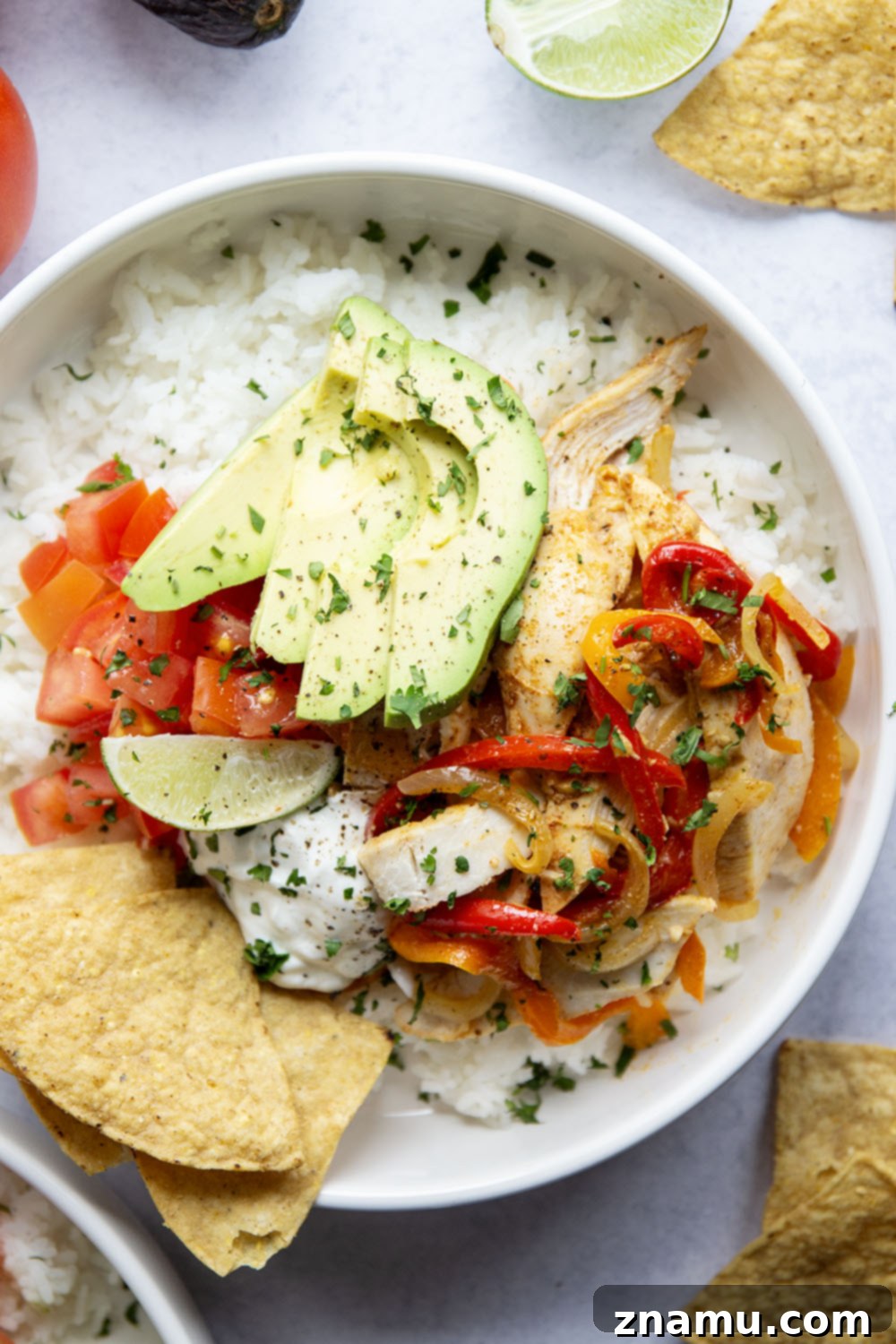 Zesty Chicken Fajita Rice Bowls 4 Everything you love about classic chicken fajitas are piled into these chicken fajita rice bowls that are made on a sheet pan for less mess and easy to meal prep!