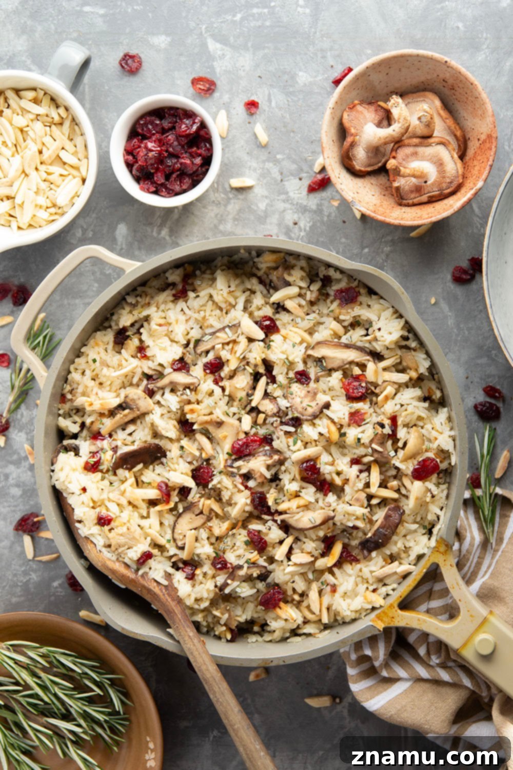 Forest-Foraged Mushroom Pilaf 4 A close-up of a serving spoon scooping up fluffy Wild Mushroom Rice Pilaf from a bowl.