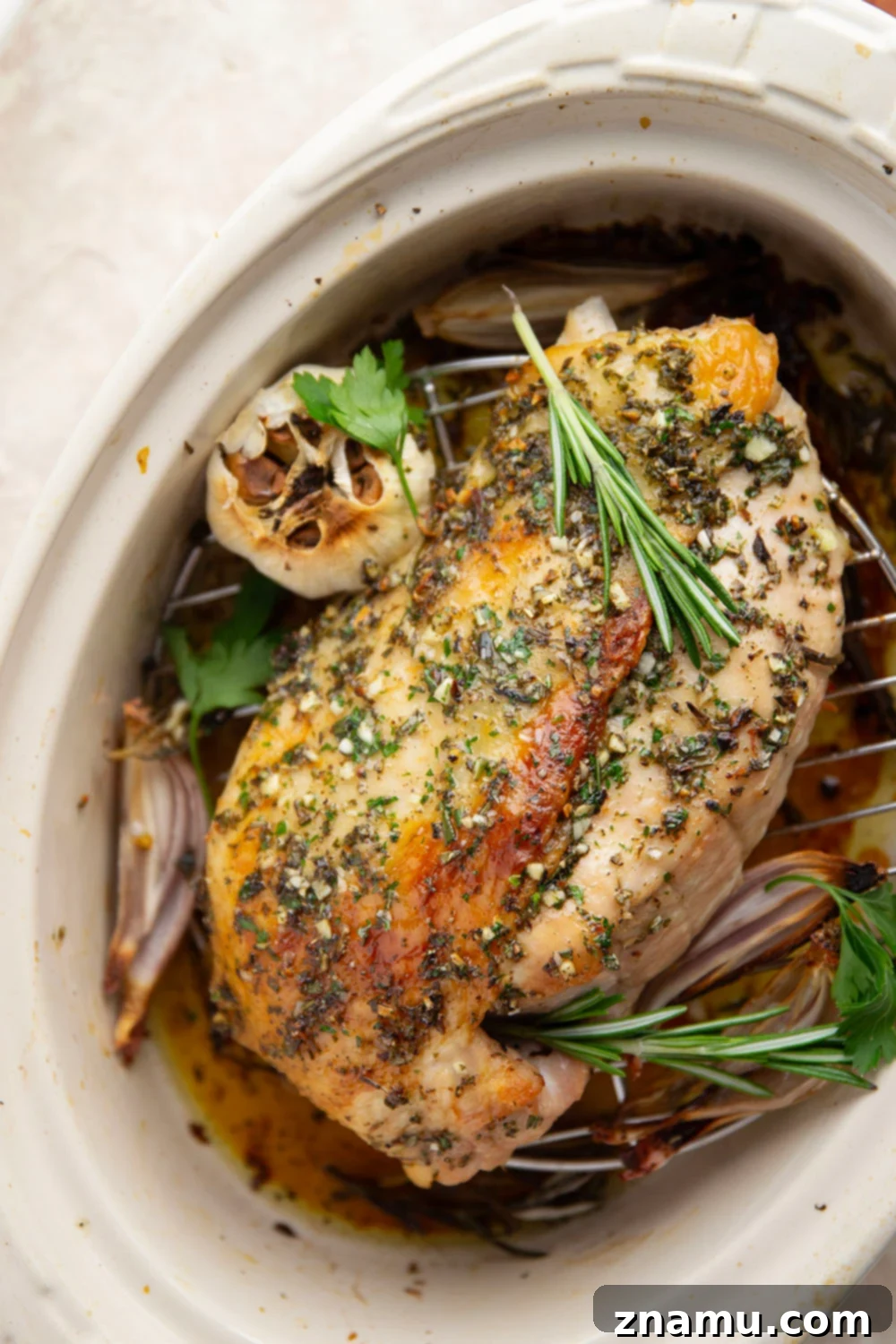 Sliced garlic herb turkey breast served with a spoonful of cranberry compote