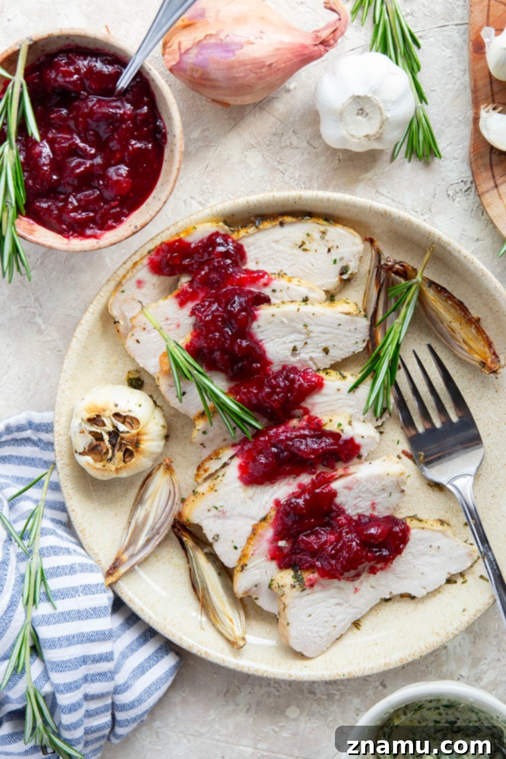 Thanksgiving dinner table with garlic herb turkey breast, sides, and wine