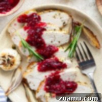 Juicy garlic herb turkey breast is roasted in a rich garlic herb butter and served with a tangy cranberry compote - perfect for a smaller-scale Thanksgiving dinner!