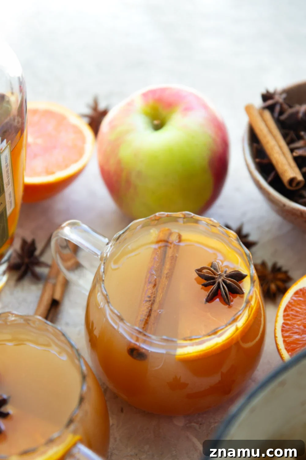 Chai-Spiced Apple Cider 6 Glasses of Chai Mulled Apple Cider with various liquor pairings, garnished with orange slices and cinnamon sticks.