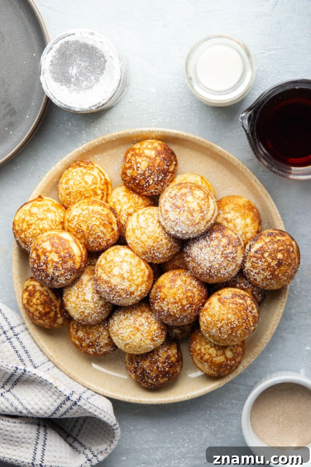 Danish Delights: Fluffy Pancake Balls 4 Close-up shot of Ebelskivers with a sprinkle of powdered sugar.