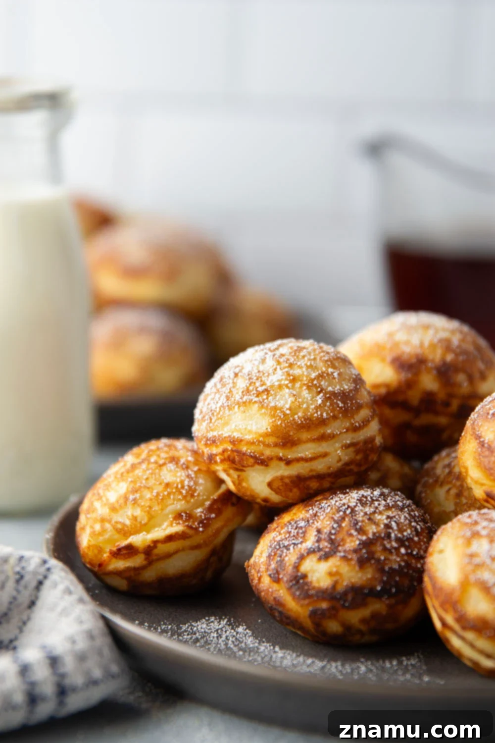 Danish Delights: Fluffy Pancake Balls 5 An Ebelskiver pan filled with cooking Ebelskivers.