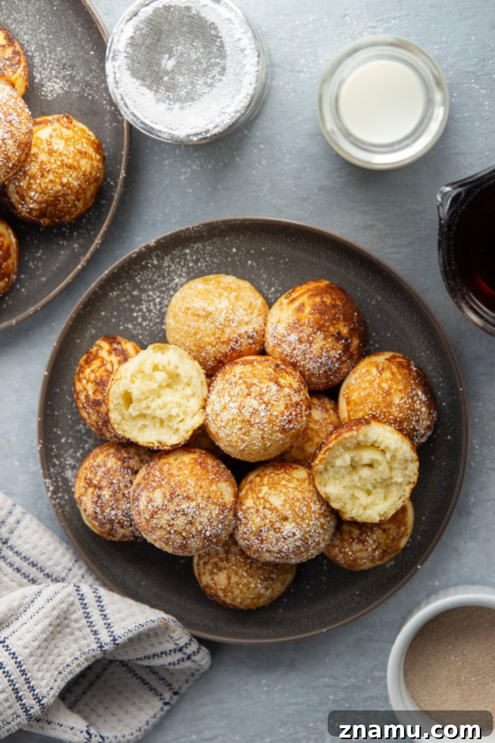 Danish Delights: Fluffy Pancake Balls 6 Ebelskivers served with maple syrup, jam, and powdered sugar.