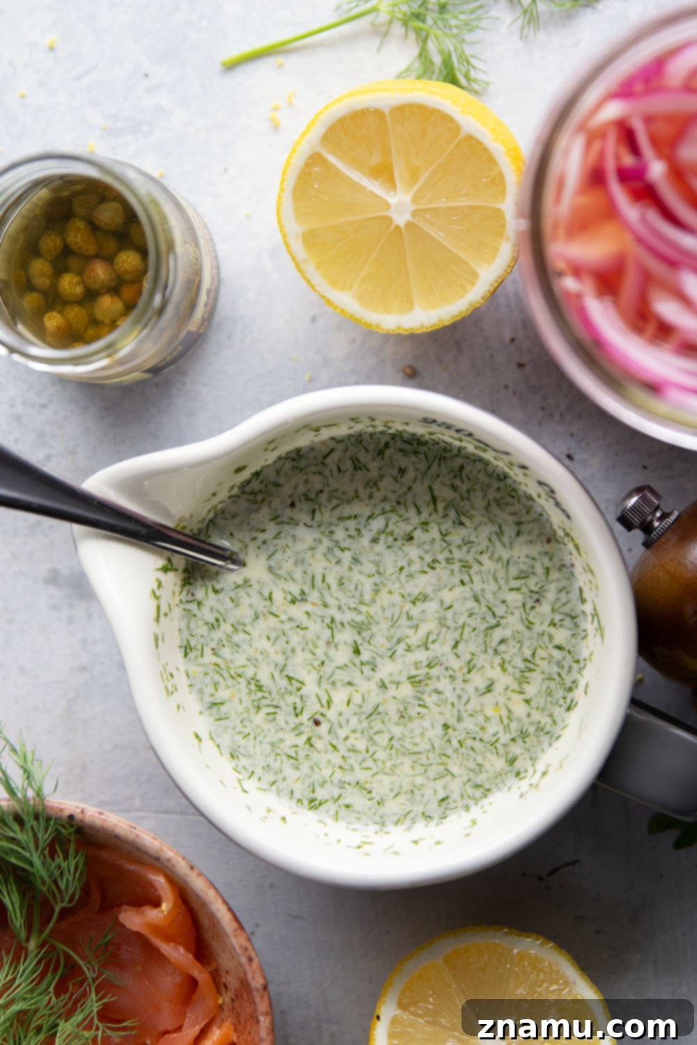 Close-up of Smoked Salmon Cucumber Salad, showcasing the creamy dill dressing and pickled red onions.