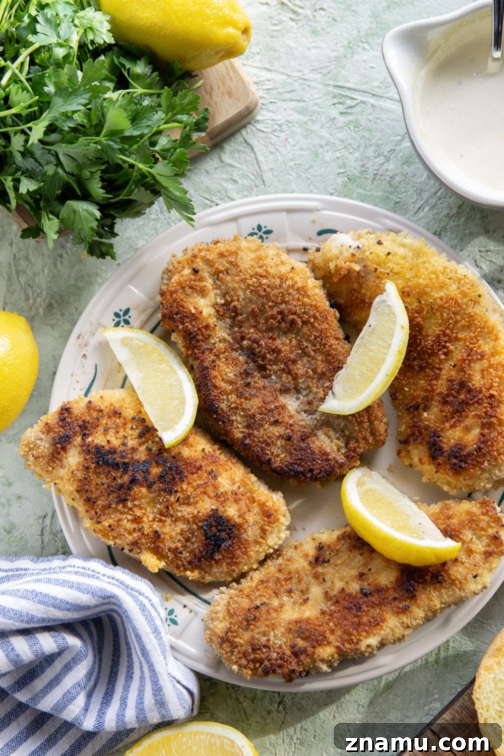Crispy Chicken Piccata on a Bun 3 Delicious Crispy Chicken Piccata Sandwich on a plate