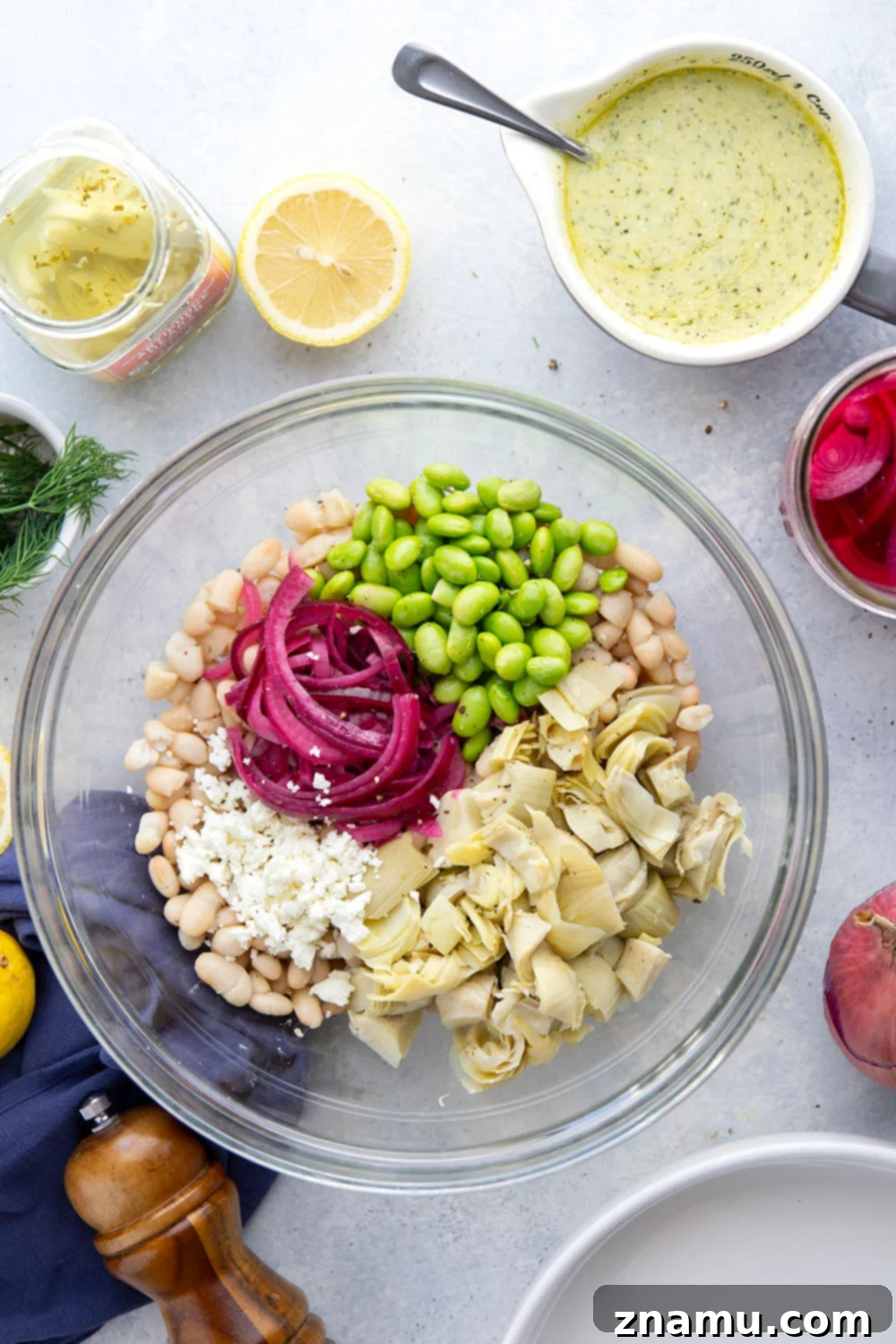 Dill Artichoke White Bean Delight 4 A bowl of fresh dill artichoke white bean salad, garnished with extra dill and lemon zest.
