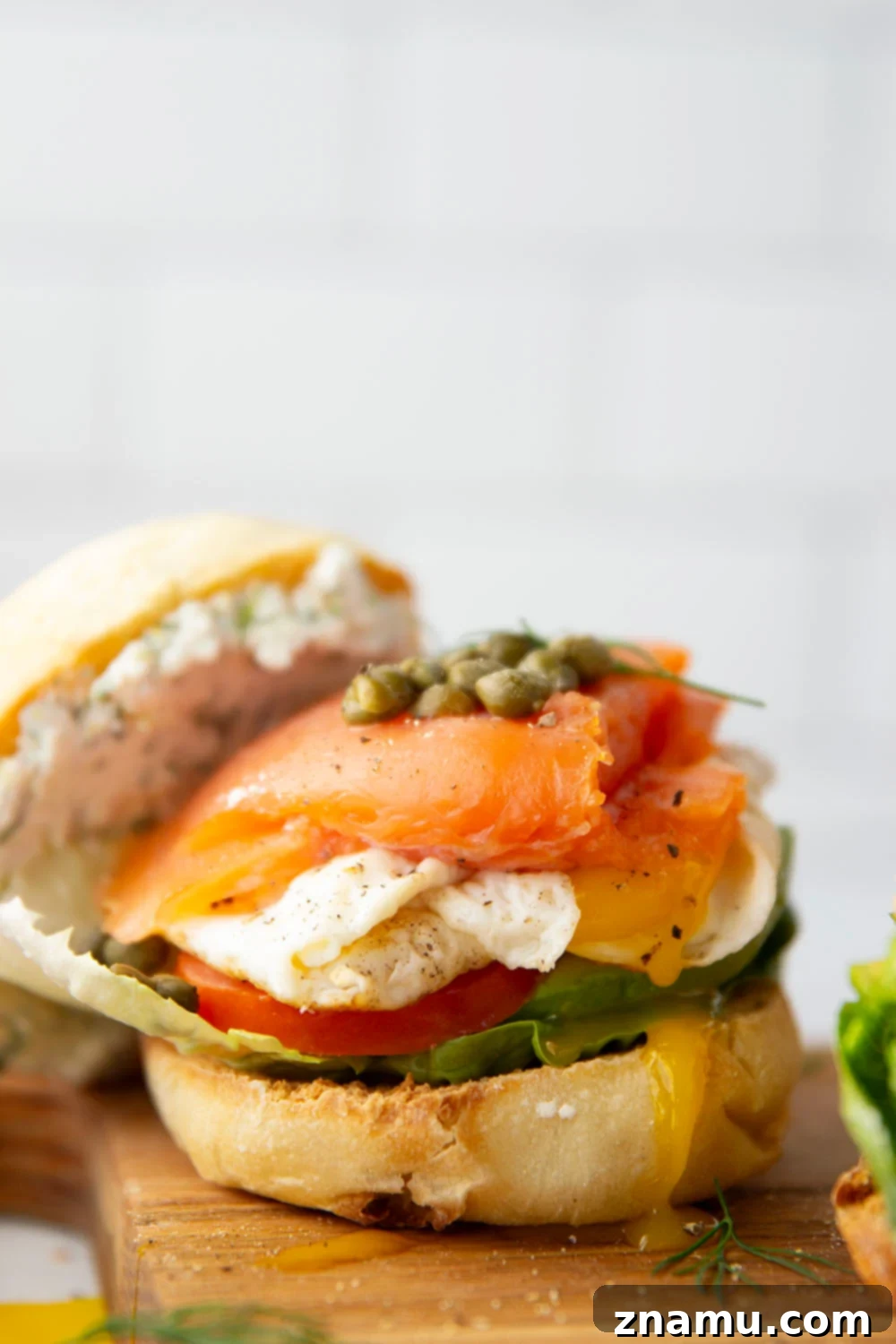 Gourmet Smoked Salmon & Goat Cheese Breakfast Sandwich 2 A gourmet smoked salmon breakfast sandwich with creamy herbed goat cheese, fresh avocado, tomato, and a perfectly cooked egg on an English muffin.