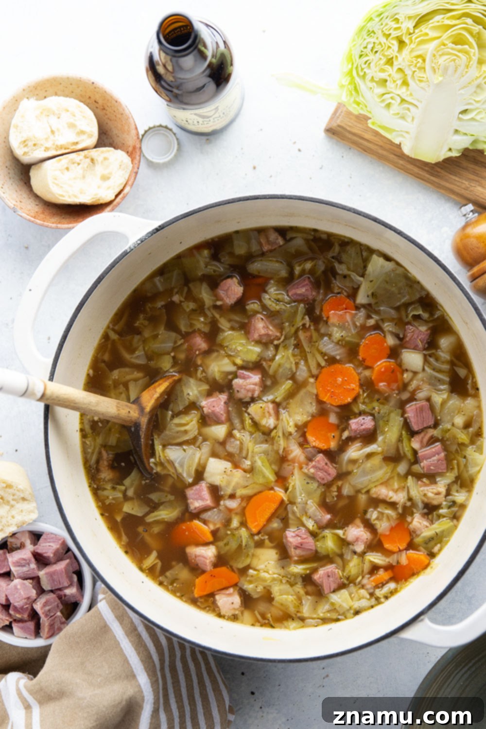 Hearty Corned Beef and Cabbage Stew 3 Close-up view of corned beef cabbage soup simmering in a large Dutch oven, showing the tender vegetables and rich broth.