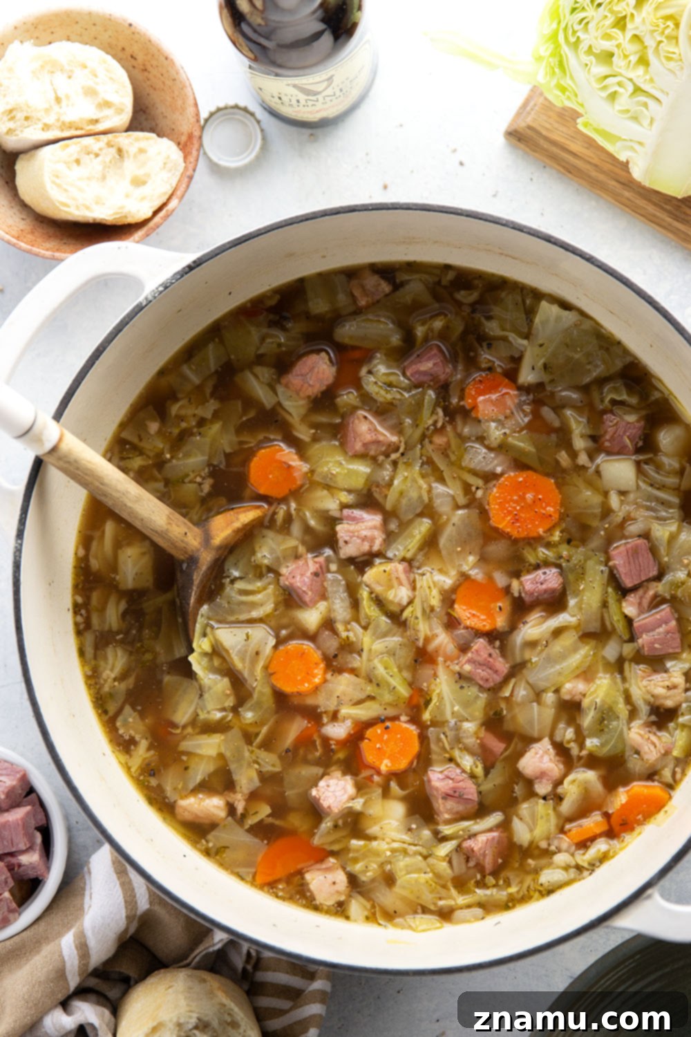 Hearty Corned Beef and Cabbage Stew 5 A beautifully presented bowl of corned beef cabbage soup, served with a slice of rustic bread, ready for a comforting meal.
