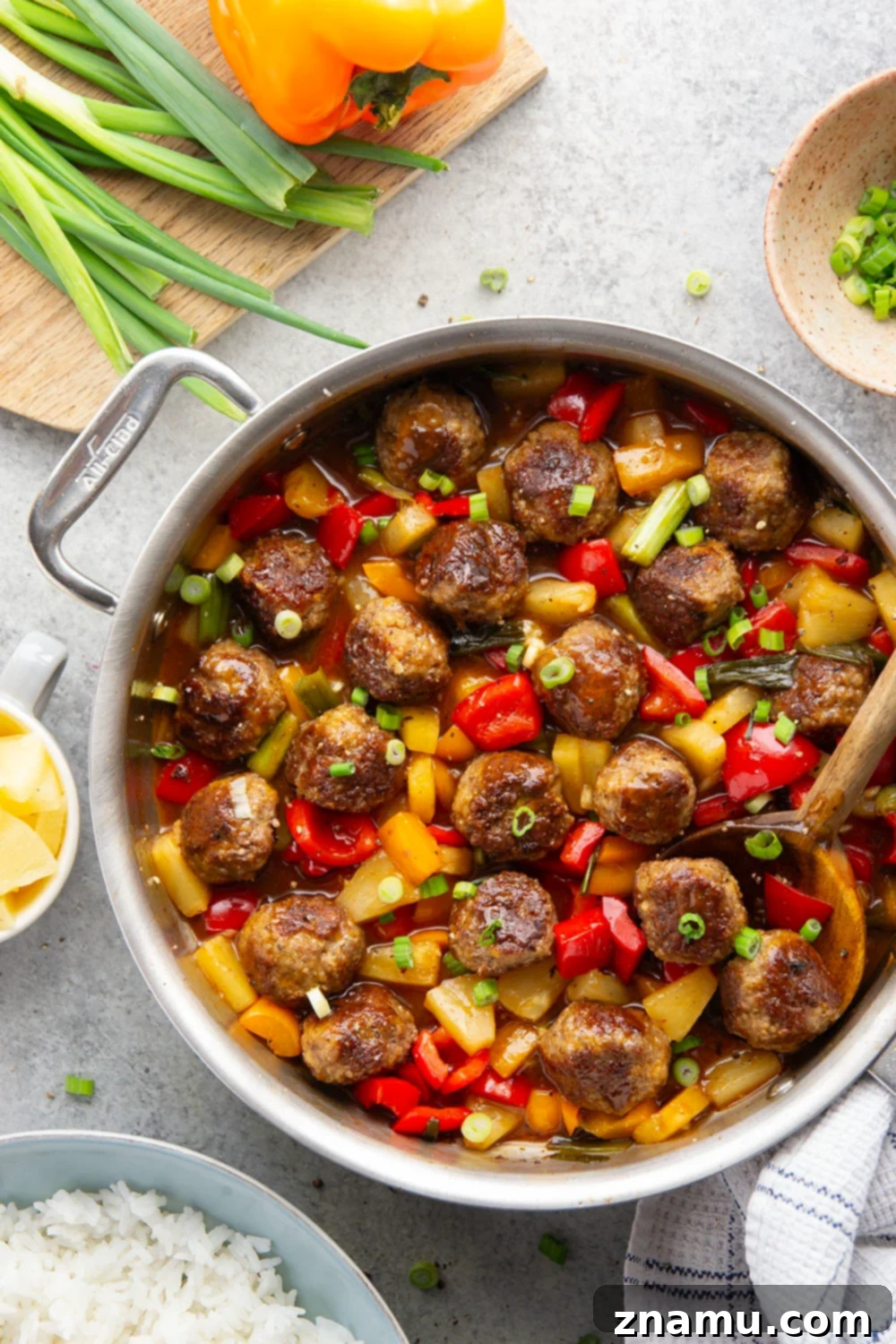 Glazed Meatballs with Peppers 2 A homemade sweet and sour sauce coats every inch of these juicy sweet and sour meatballs that cook up with colorful peppers and sweet pineapple all in one pan.