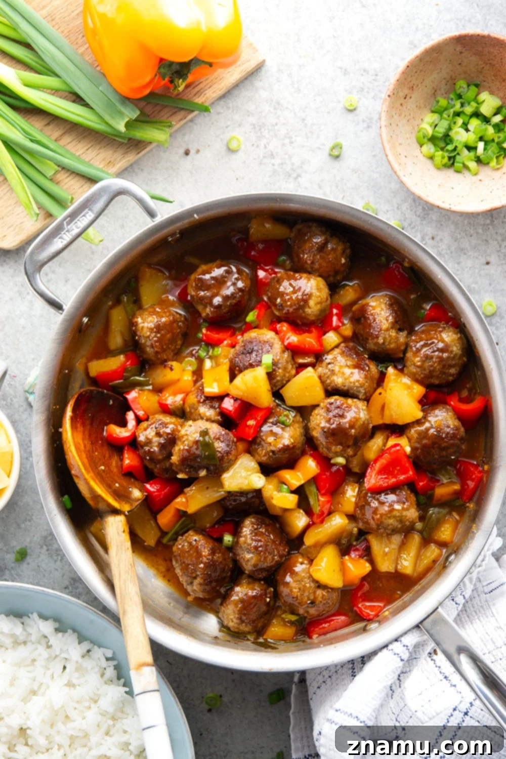 Glazed Meatballs with Peppers 5 A homemade sweet and sour sauce coats every inch of these juicy sweet and sour meatballs that cook up with colorful peppers and sweet pineapple all in one pan.