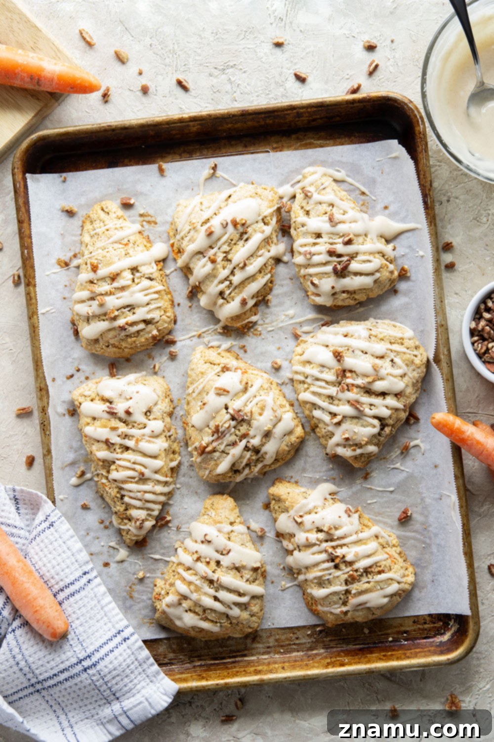 Spiced Carrot Cake Scones 3 Soft and tender carrot cake scones feature lots of toasted pecans, shredded carrots, and a silky cream cheese glaze drizzled on top.