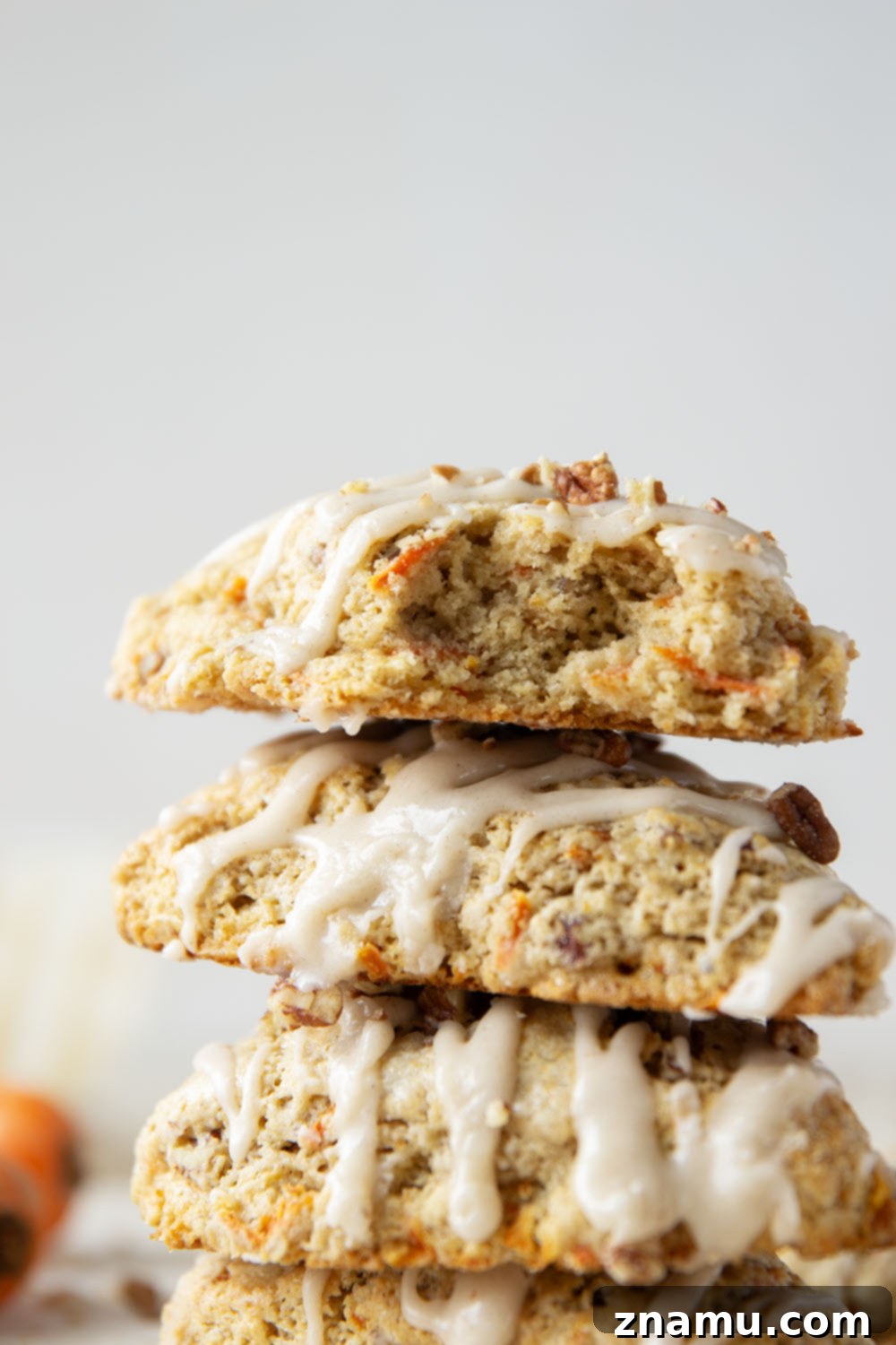 Spiced Carrot Cake Scones 5 Soft and tender carrot cake scones feature lots of toasted pecans, shredded carrots, and a silky cream cheese glaze drizzled on top.