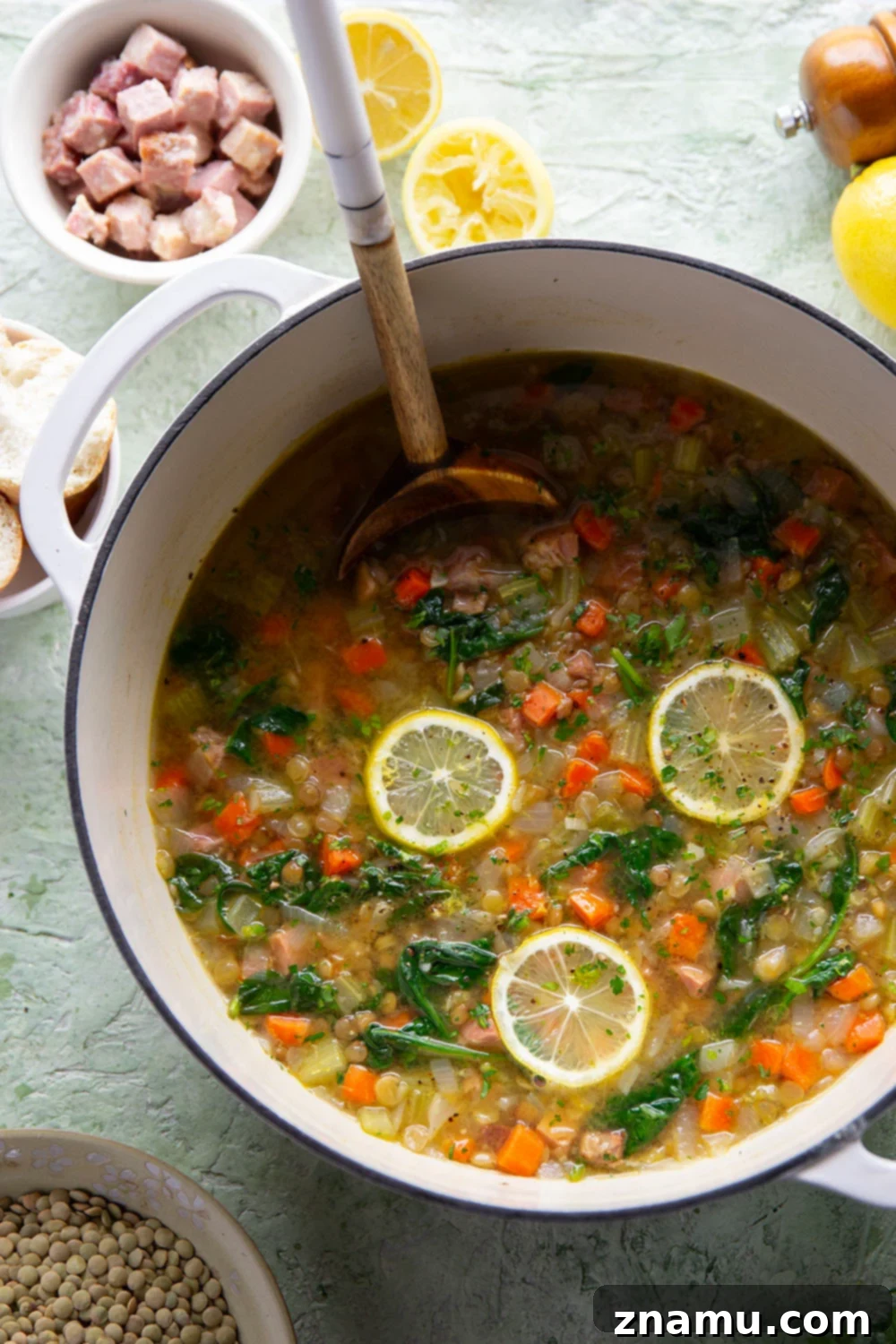 Hearty Lemon Lentil and Ham Soup 5 A large pot of Lemon Lentil Ham Soup ready to be served, with a ladle resting inside.
