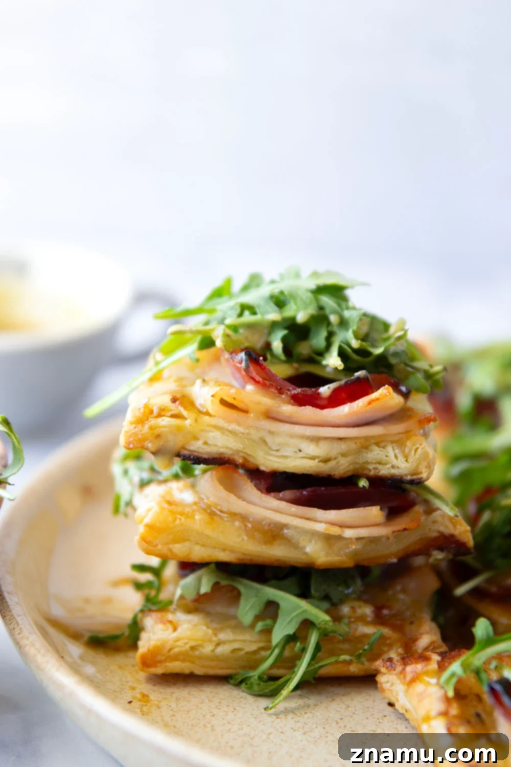 Flaky Chicken Cordon Bleu Tartlets 2 These savory cordon bleu puff pastry tarts have everything you'll find in the classic chicken dish in hand-held tart form! These tarts feature layers of deli ham, chicken, and Swiss cheese slices with a tangy honey mustard and lots of arugula piled on top.